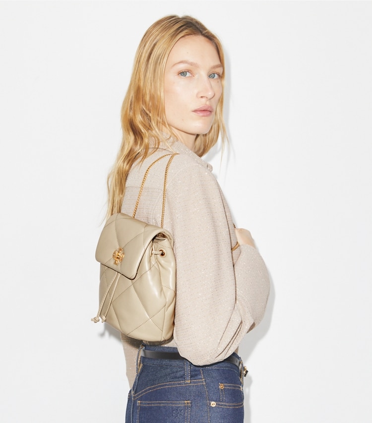 Tory Burch designer backpacks Mini Kira Diamond Quilt Backpack in Light Stone accessory on model