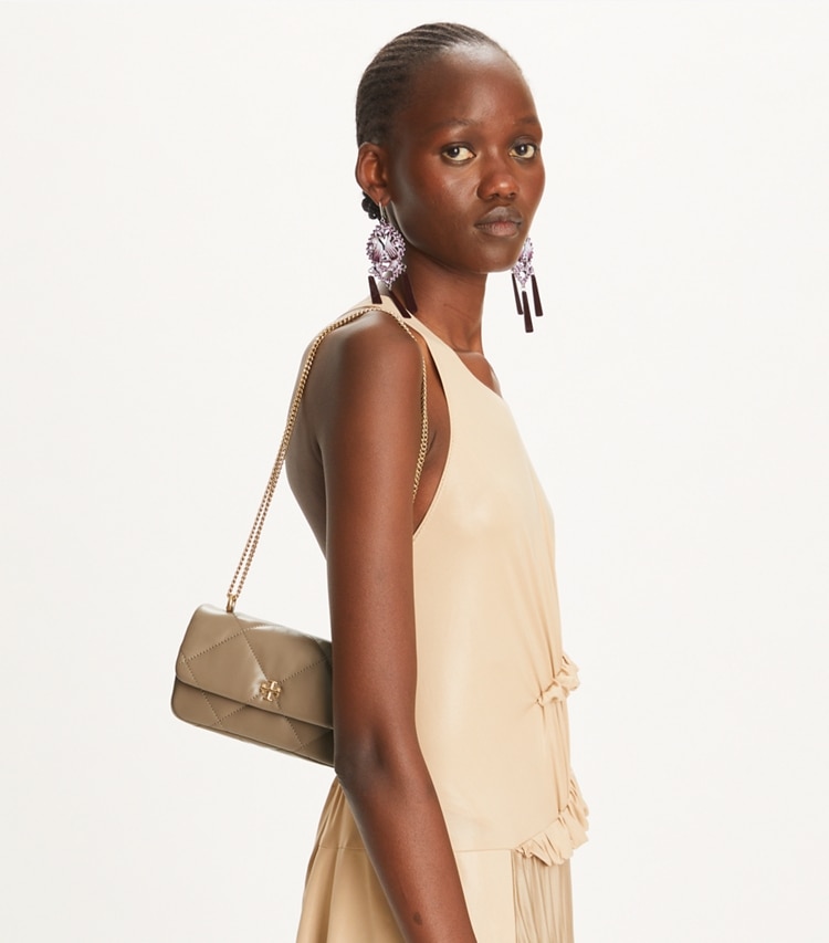 Tory Burch designer crossbody bags Mini Kira Diamond Quilt Flap Bag in Taupe Oak accessory on model