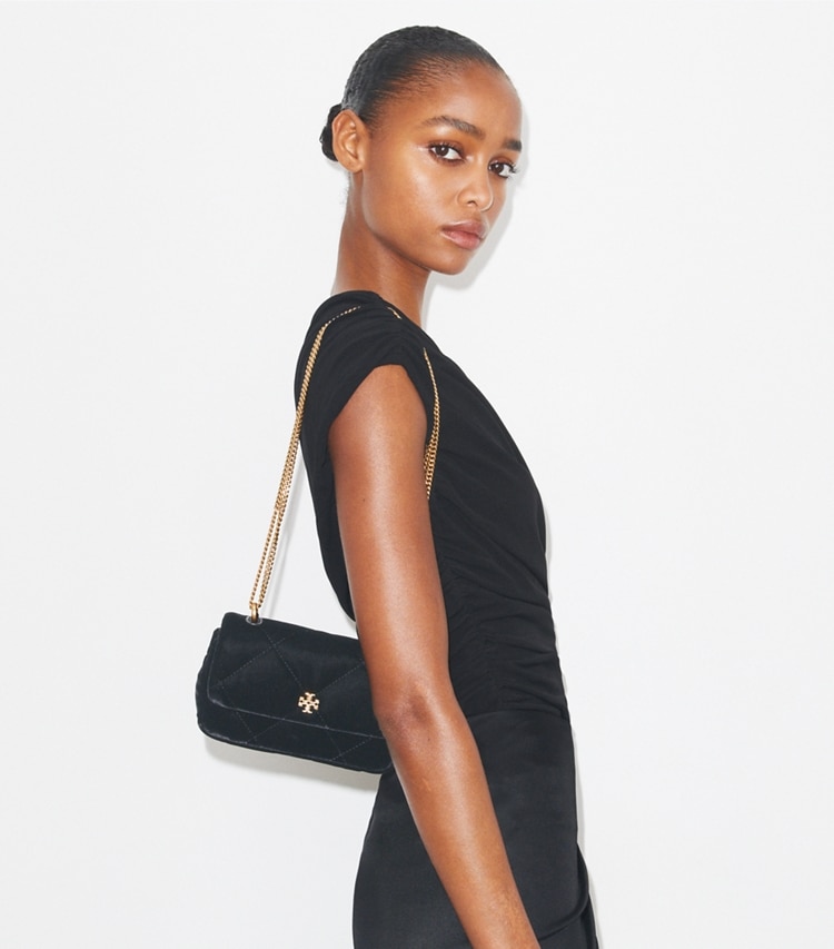 Tory Burch designer crossbody bags Mini Kira Diamond Quilt Velvet Pavé Flap Bag in Black accessory on model