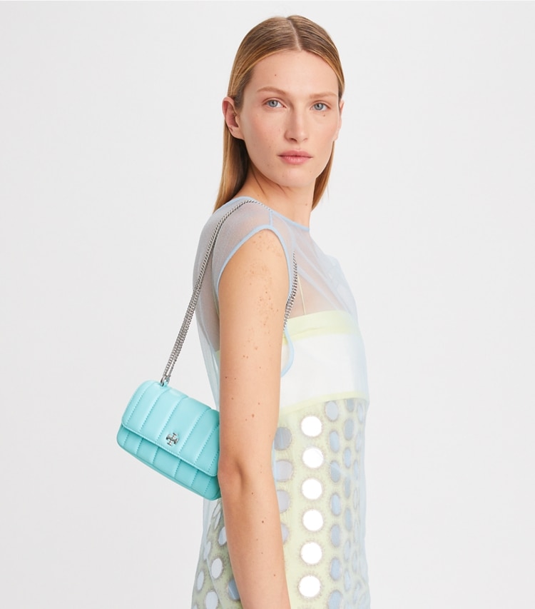 Tory Burch designer crossbody bags Mini Kira Flap Shoulder Bag in Light Celeste accessory on model