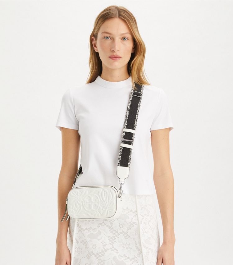 Tory Burch designer crossbody bags Mini Miller Floral Embossed Crossbody Bag in Blanc accessory on model