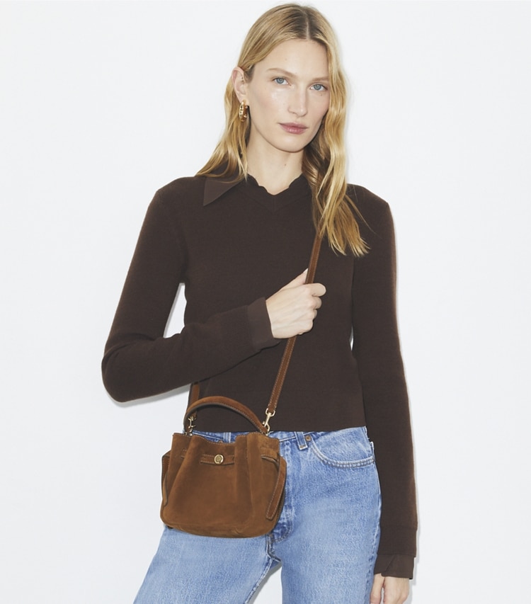 Tory Burch designer crossbody bags Mini Romy Suede Bucket Bag in Caramel accessory on model