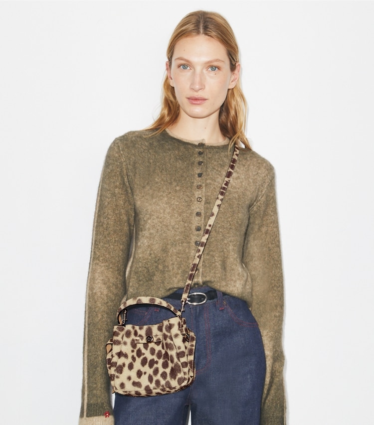 Tory Burch designer crossbody bags Mini Romy Suede Bucket Bag in Cheetah Spots accessory on model