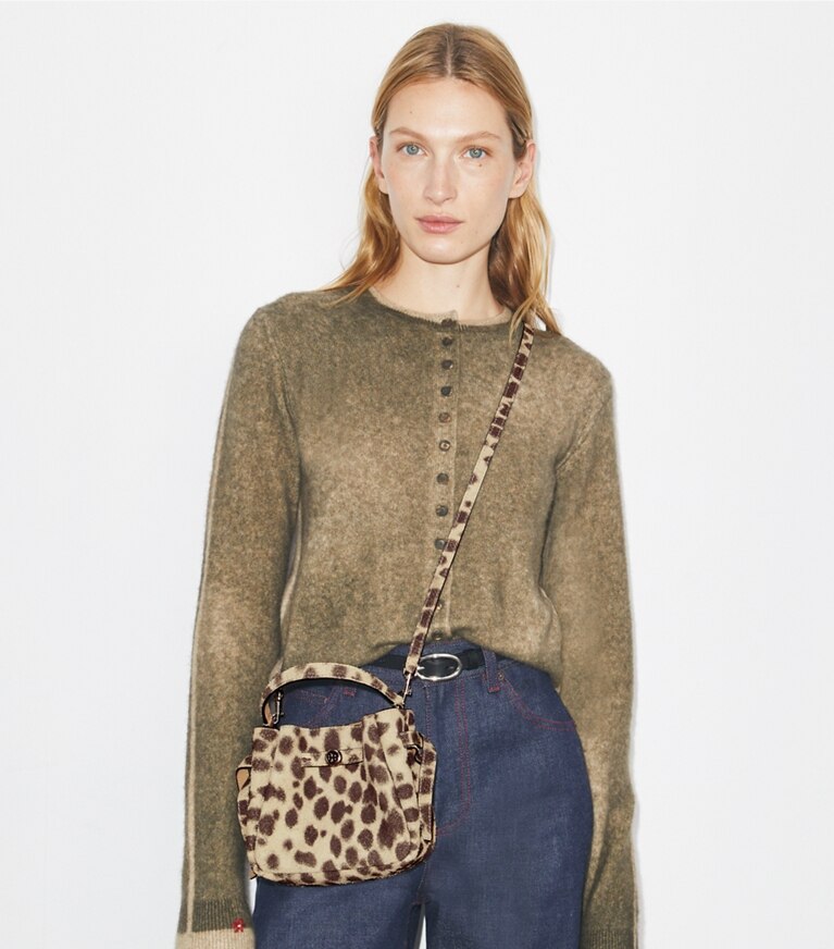 Tory Burch designer crossbody bags Mini Romy Suede Bucket Bag in Cheetah Spots accessory on model