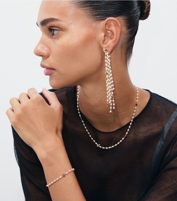 Tory Burch designer necklaces Moondance Delicate Pearl Star Necklace in Tory Gold / Cream accessory on model
