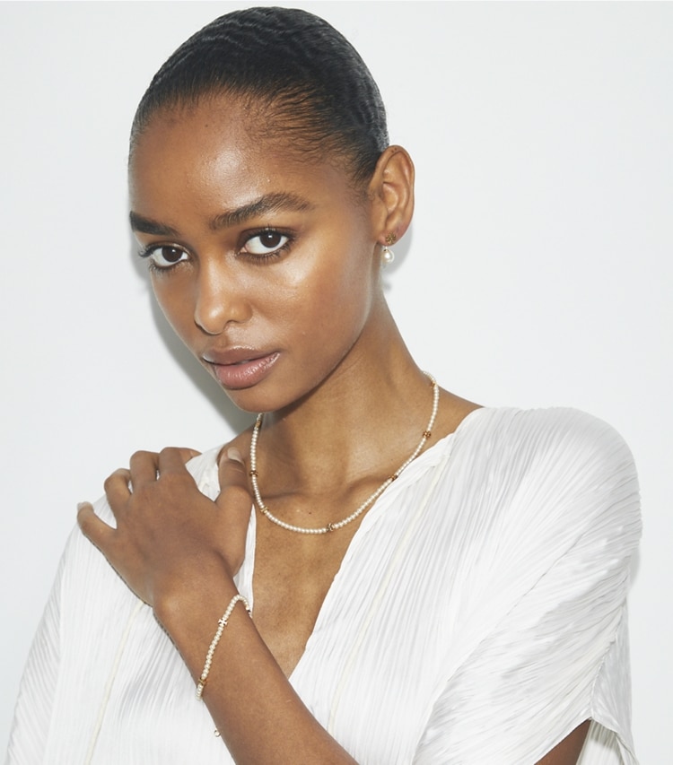 Tory Burch designer earrings Moondance Pearl Front-Back Earrings in Tory Gold / Pearl accessory on model