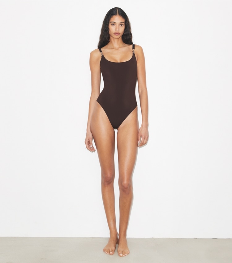 Tory Burch designer one pieces One-Shoulder Clip Swimsuit in Dark Brown on model front