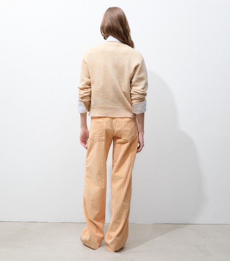 Tory Burch designer bas Pantalon en velours côtelé Buddy dans Apricot sur modèle, de dos