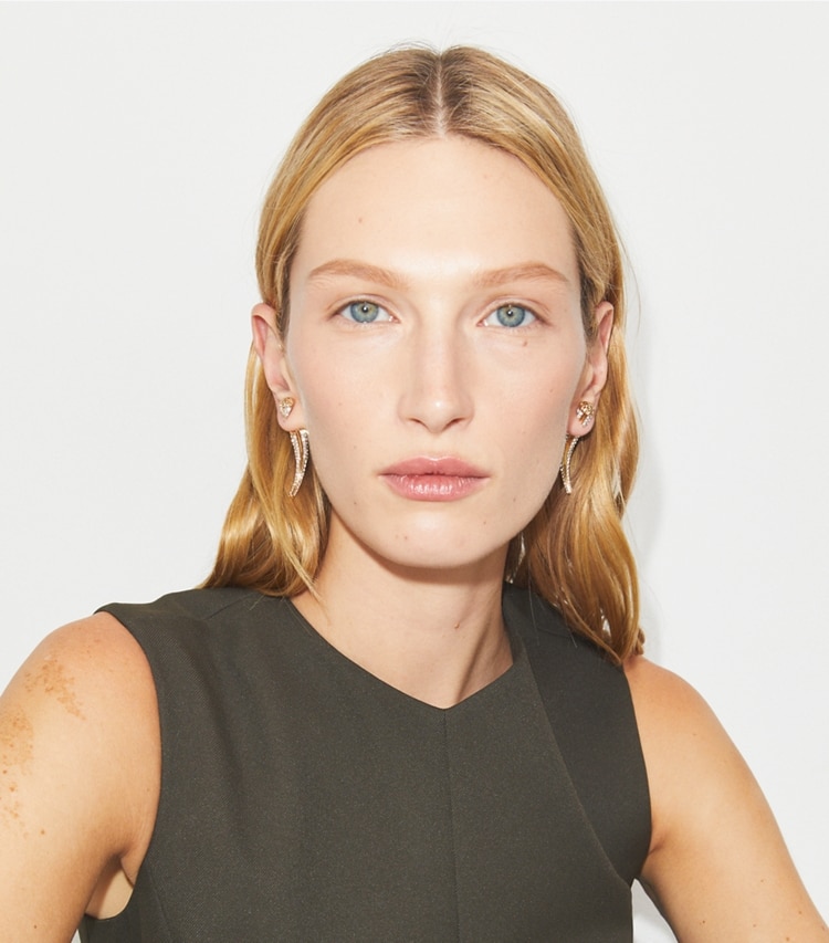 Tory Burch designer earrings Pavé Logo Spike Front-Back Earring in Light Brass / Crystal accessory on model