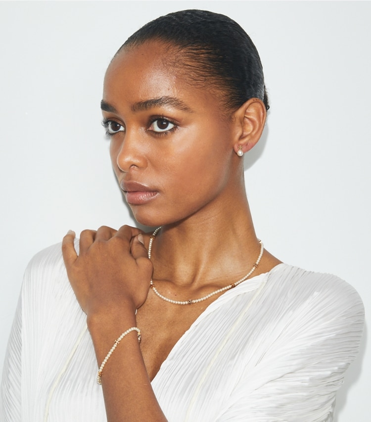 Tory Burch designer earrings Pearl Stud Earrings in Tory Gold / Pearl accessory on model