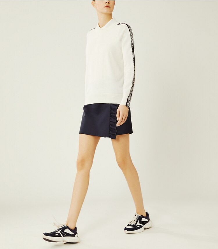 Tory Sport designer sweaters Performance Merino Geo-T Sweater in Snow White on model front