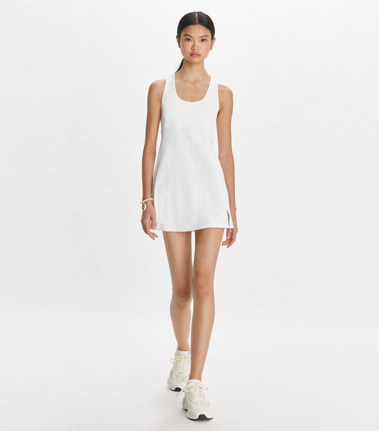 Tory Sport designer dresses Performance Mesh Tennis Dress in Snow White on model front