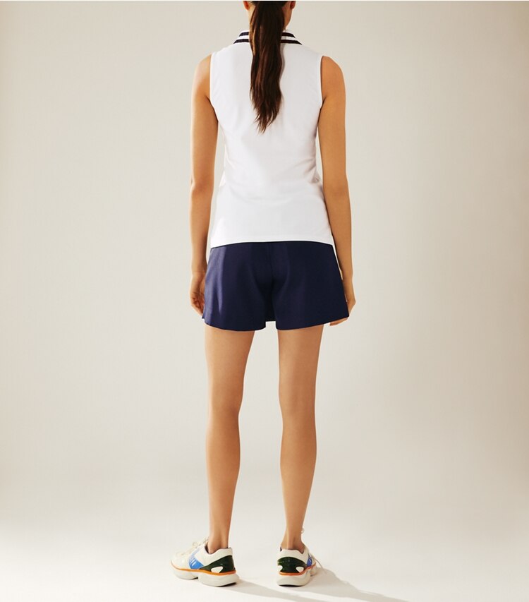 Tory Sport designer tops Performance Piqué Pleated-Collar Sleeveless Polo in Snow White on model back