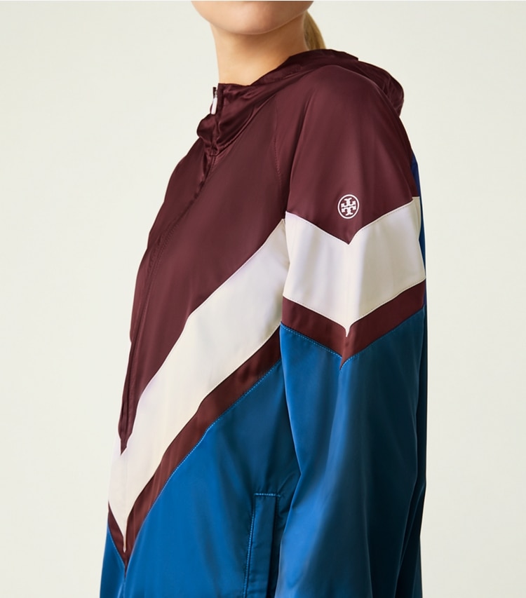 Tory Sport designer jackets Performance Satin Chevron Running Jacket in Winetasting / Blue Wash on model detail