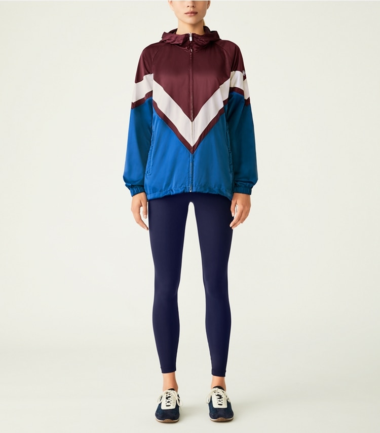 Tory Sport designer jackets Performance Satin Chevron Running Jacket in Winetasting / Blue Wash on model front