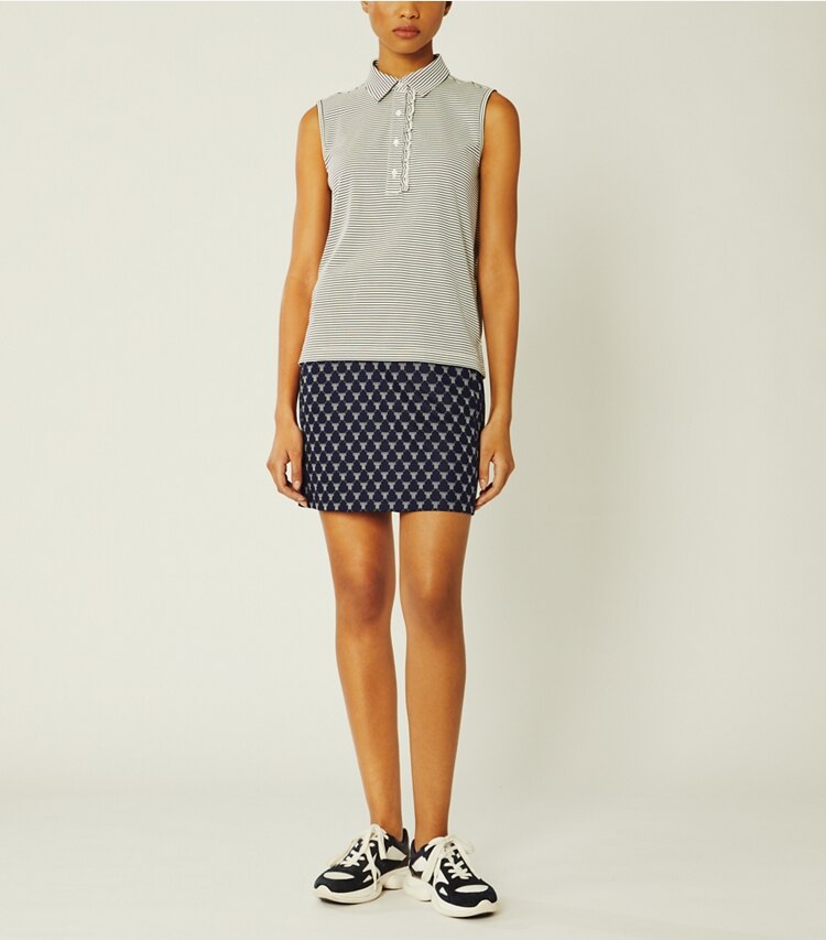 Tory Sport designer tops Performance Striped Sleeveless Ruffle Polo in Snow White/Tory Navy Pin Stripe on model front