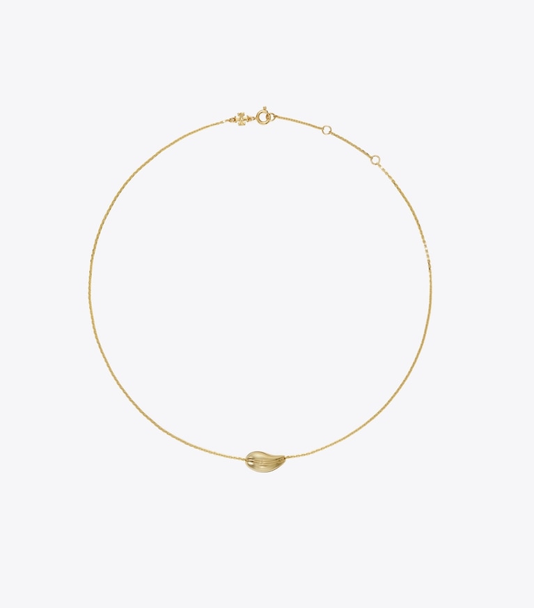 Tory Burch designer colliers Petit pendentif ajouré dans Light Brass de face