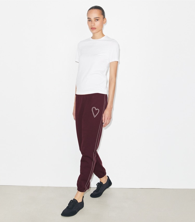 Tory Burch designer bottoms Pick Stitch Heart French Terry Sweatpant in Dark Merlot on model front