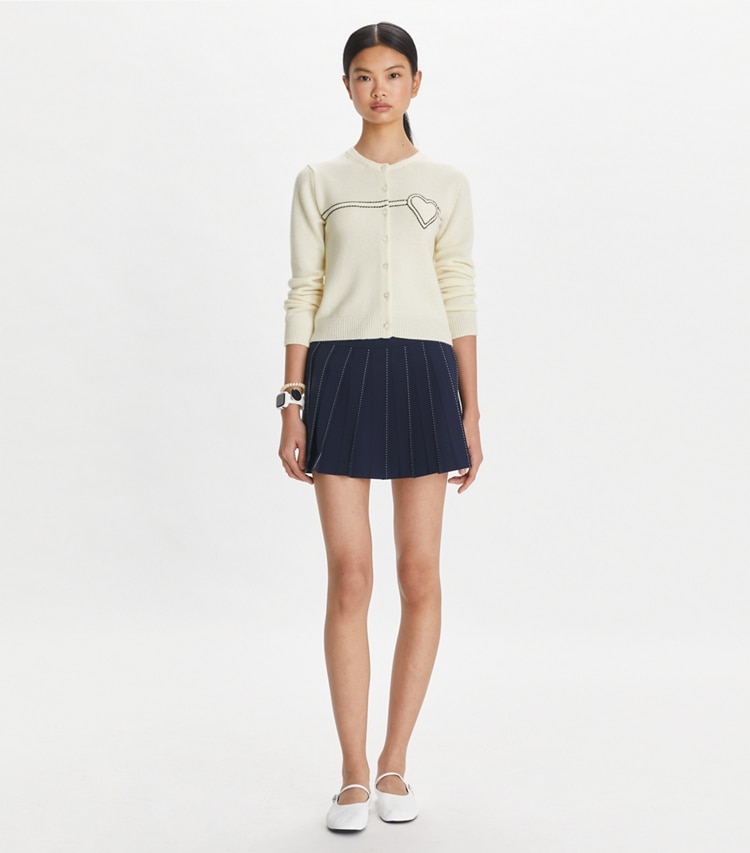 Tory Sport designer bottoms Pickstitch Pleated Skirt in Tory Navy on model front