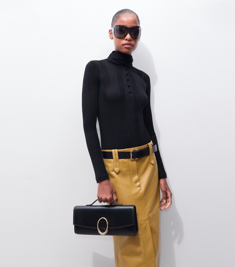 Tory Burch designer clutches Pierced Clutch in BLACK accessory on model