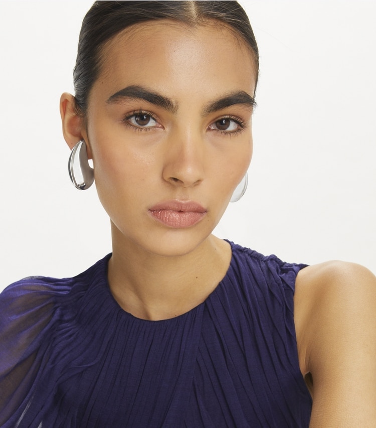 Tory Burch designer earrings Pierced Earrings in Light Brass accessory on model