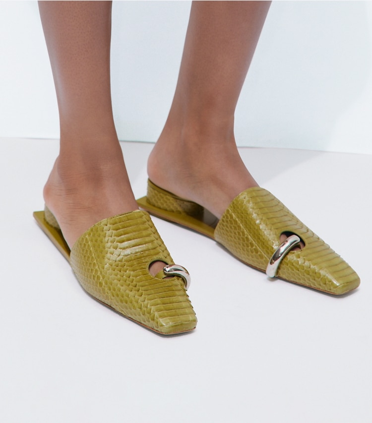 Tory Burch designer flats Pierced Mule in MOSS / SILVER accessory on model