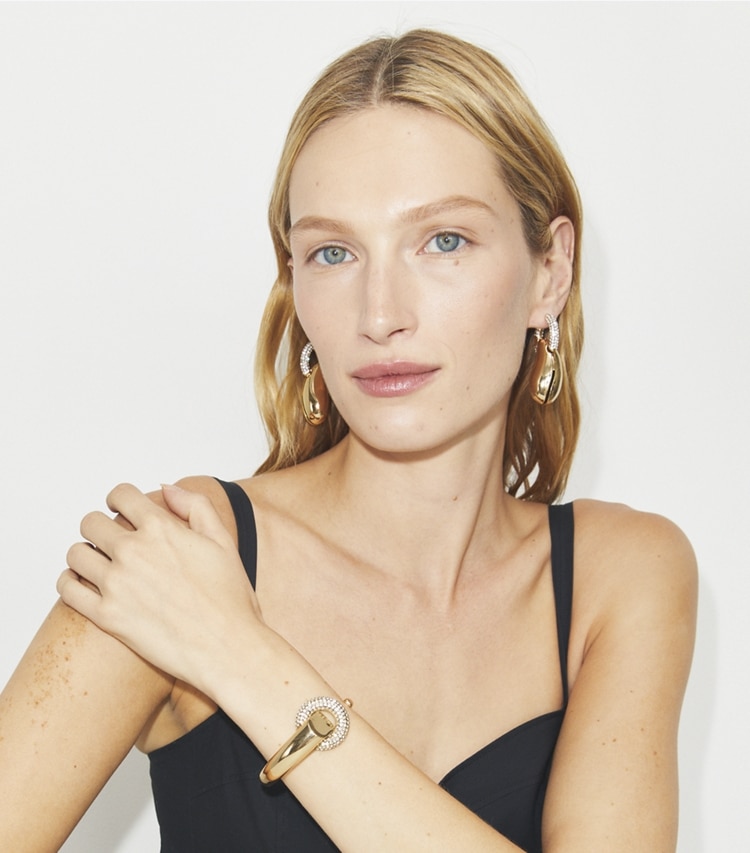 Tory Burch designer earrings Pierced Pavé Hoop Earrings in Light Brass / Crystal accessory on model