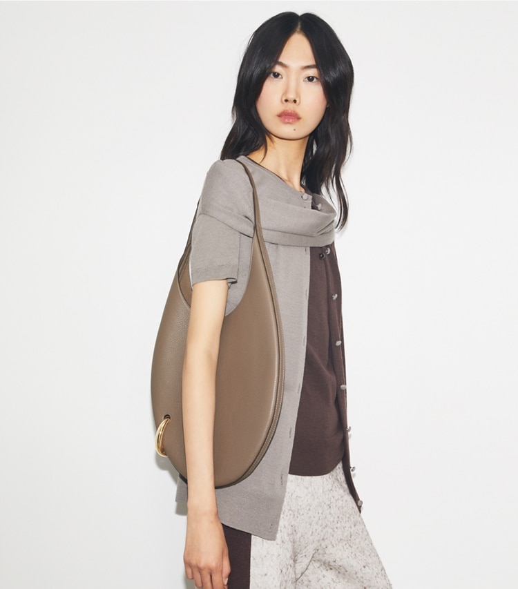 Tory Burch designer shoulder bags Pierced Pebbled Handbag in Portobello accessory on model