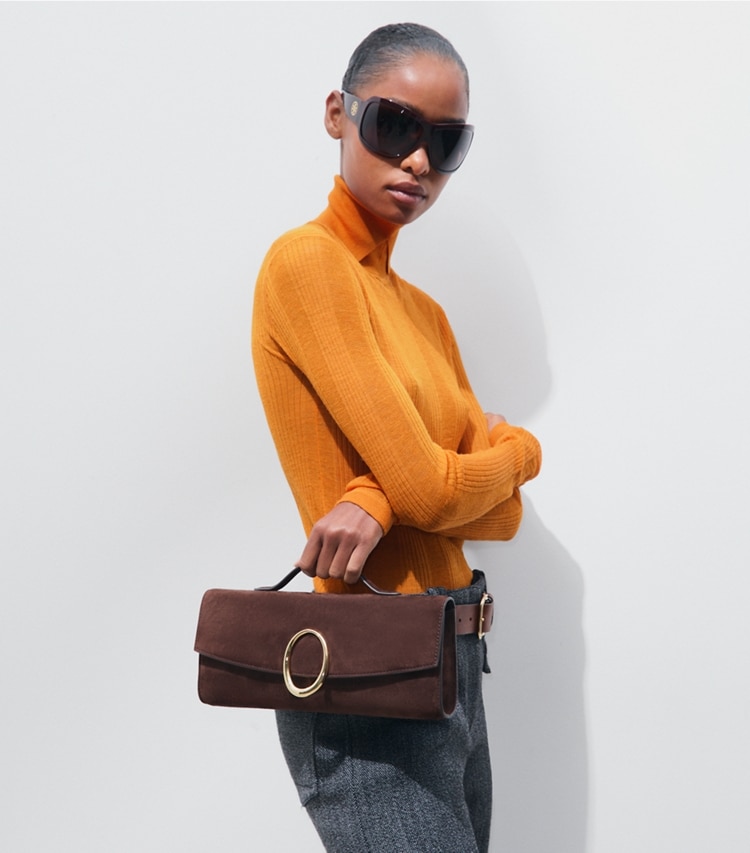 Tory Burch designer clutches Pierced Suede Clutch in Dark Cocoa accessory on model