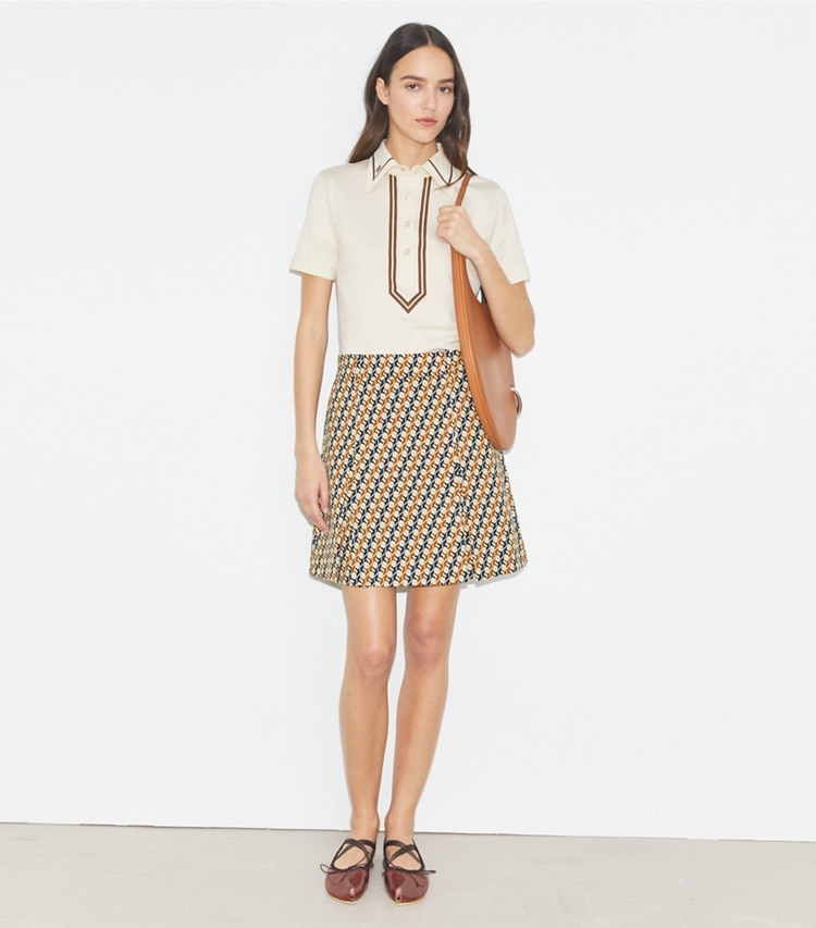 Tory Burch designer bottoms Pleated Golf Skirt in Tory Navy Linked Geo Multi-Color on model front