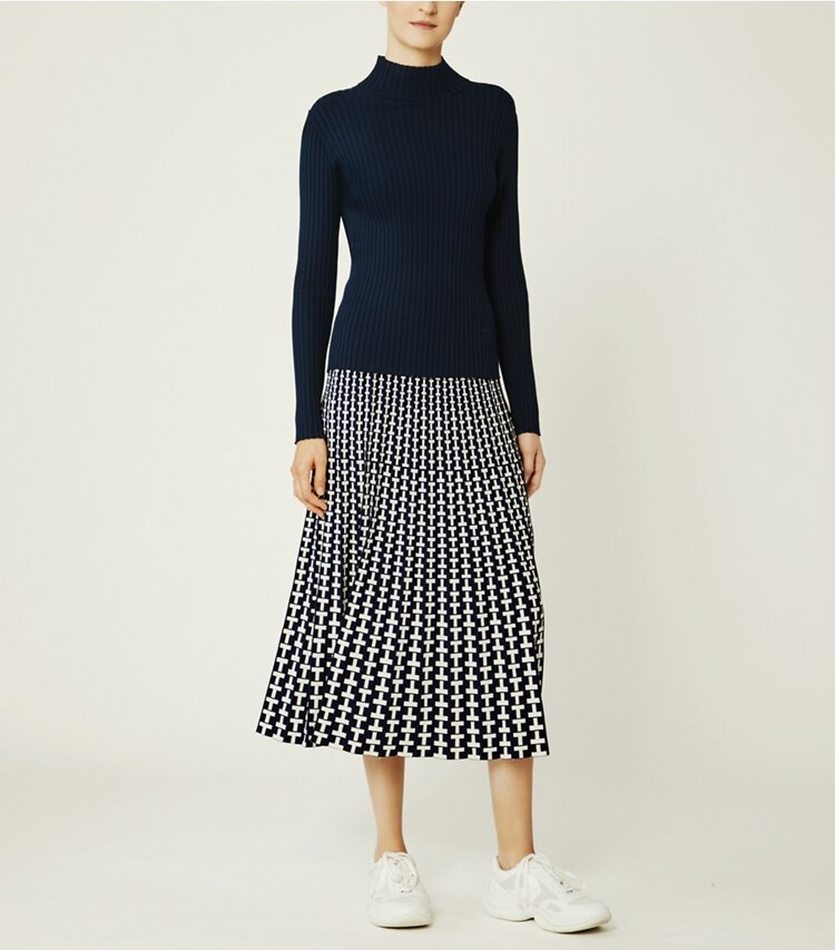 Tory Sport designer bottoms Pleated Jacquard Tech Knit Skirt in Tory Navy Two Way T on model front