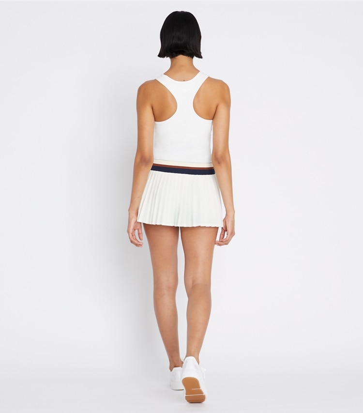 Tory Sport designer bottoms Pleated Mini Tennis Skirt in Snow White / Tory Navy on model back