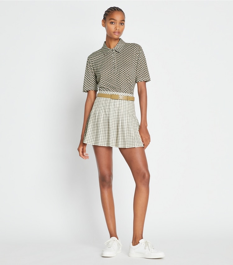 Tory Sport designer bottoms Pleated Printed Tennis Skirt in Sesame Petite Plaid on model front