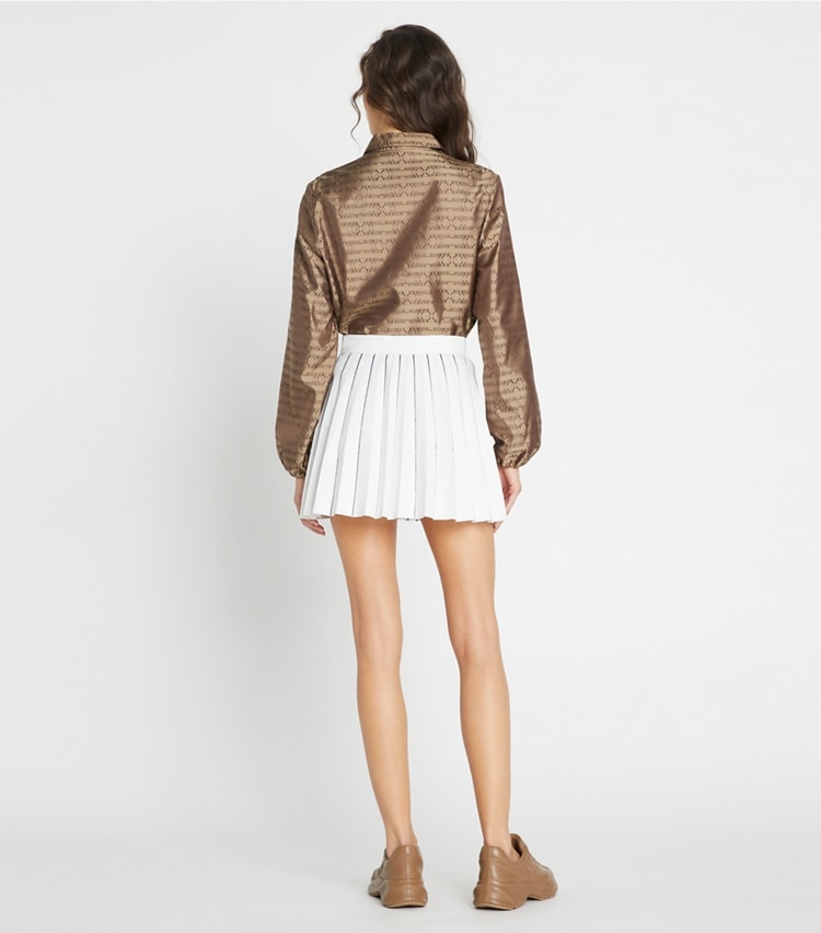Tory Sport designer bottoms Pleated Tech Knit Skirt in Snow White / Tory Navy on model back