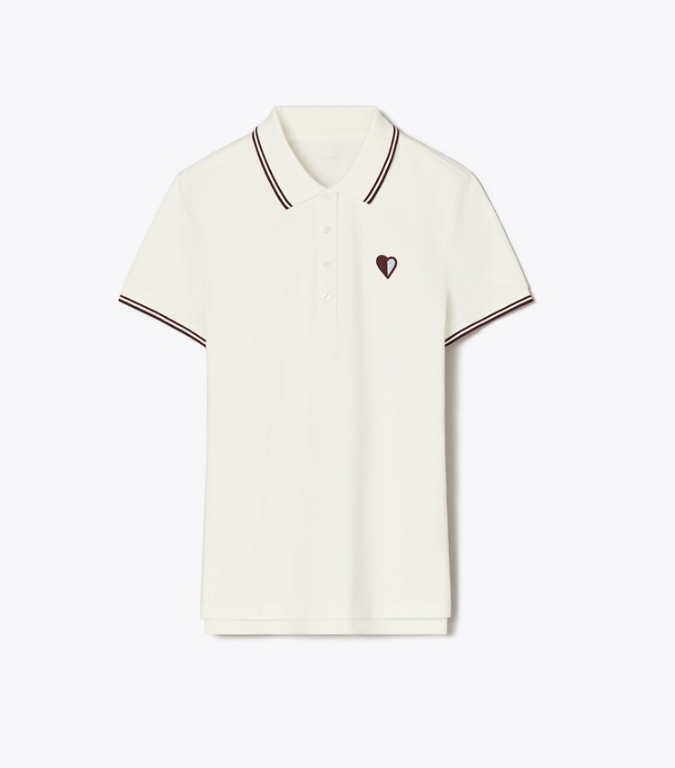Tory Burch diseñador tops Polo de piqué de alto rendimiento con corazones en Snow White / Dark Merlot frente