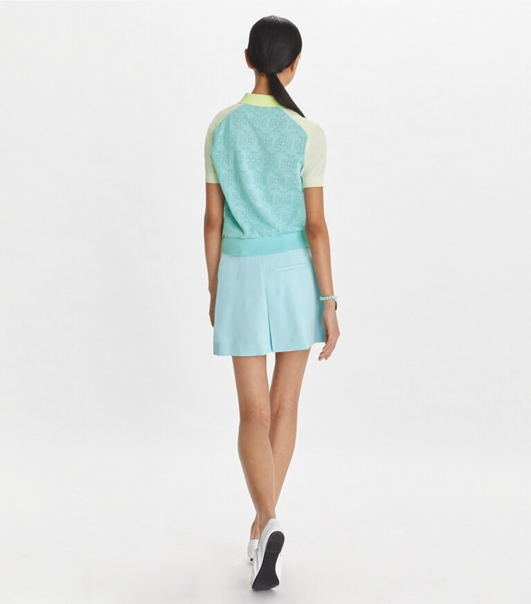 Tory Sport designer strickware Poloshirt aus Baumwolle mit Pointelle-Muster und Logo in Pastel Sky / NEW IVORY front