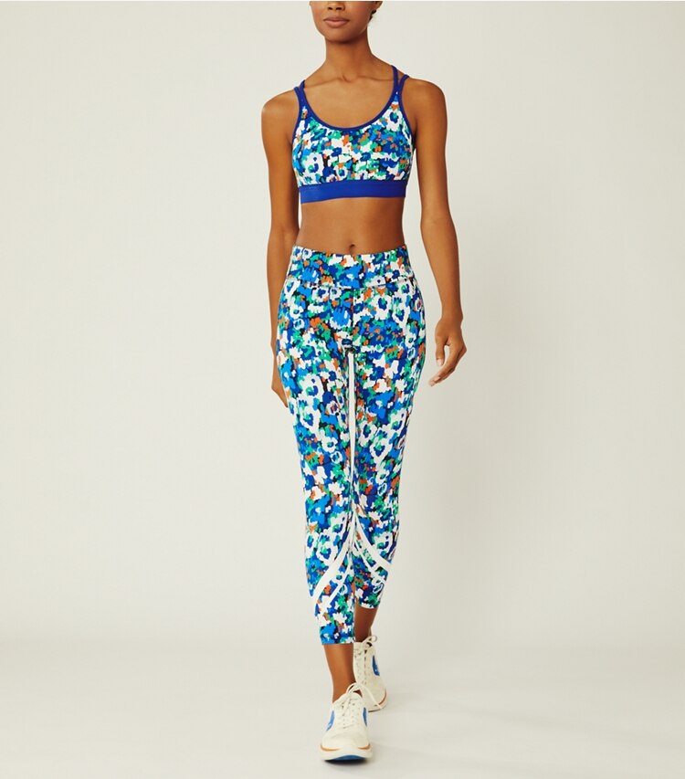 Tory Sport designer bottoms Printed Chevron 7/8 Leggings in Royale Camo Floral on model front