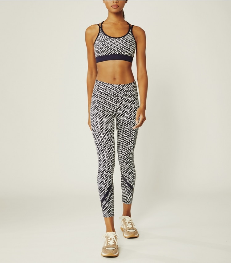 Tory Sport designer sports bras Printed Cross-Back Bra in Tory Navy Diagonal T on model front