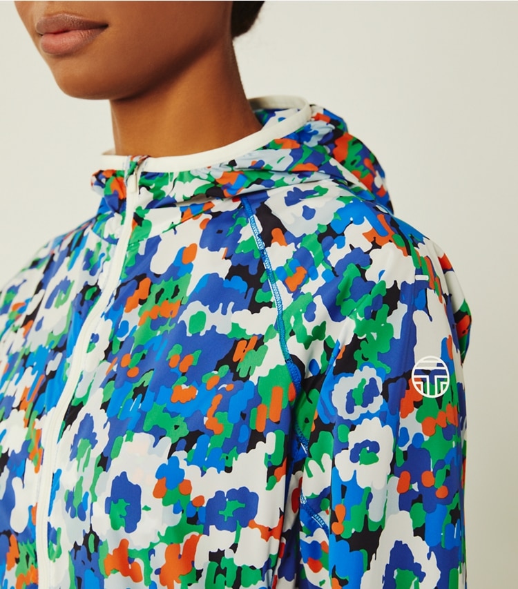 Tory Sport designer jackets Printed Nylon Packable Jacket in Royale Camo Floral on model detail