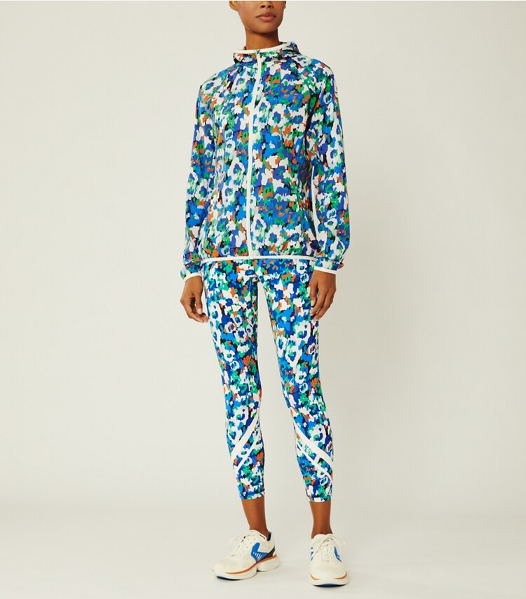 Tory Sport designer jackets Printed Nylon Packable Jacket in Royale Camo Floral on model front