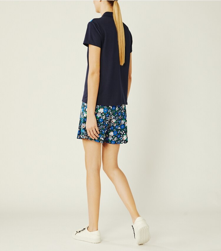 Tory Sport designer bottoms Printed Tech Twill Golf Skort in Tory Navy/Frost Primary Floral on model back