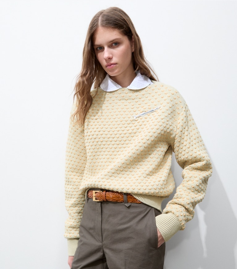 Tory Burch designer sweaters Raffia Embroidered Wool Sweater in Pale Almond / Raffia on model detail