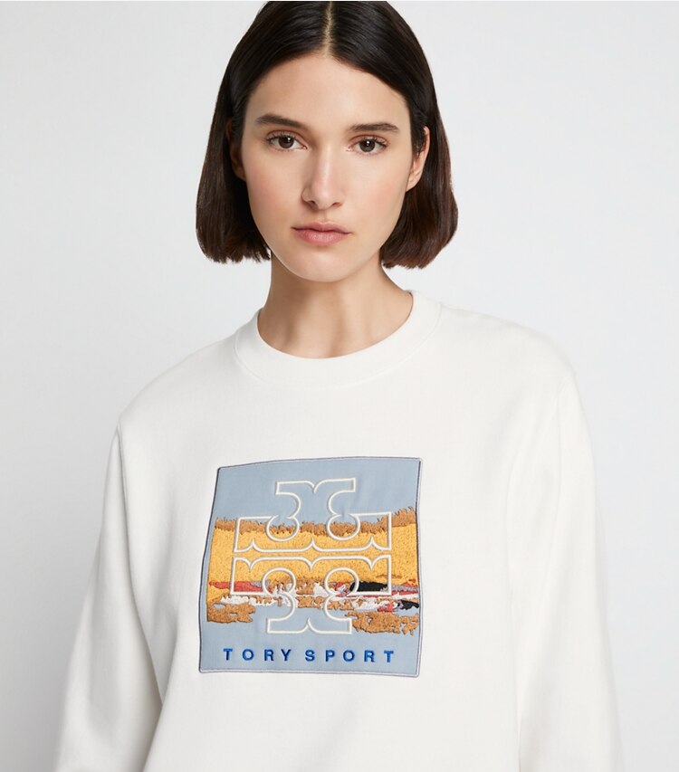 Tory Sport designer sweaters Relaxed Heavyweight French Terry Logo Patch Crew in Snow White on model detail