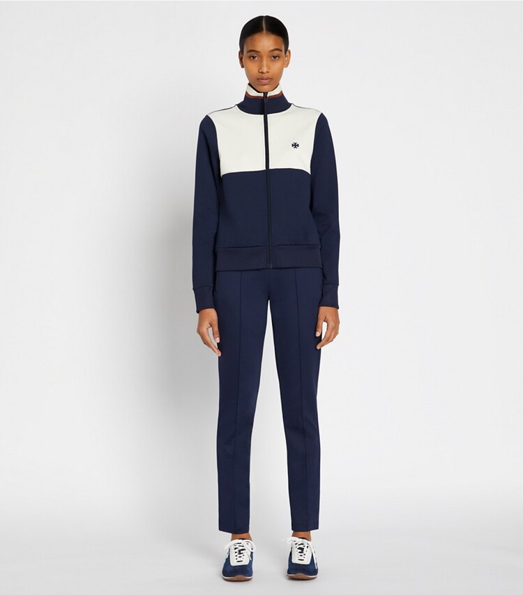 Tory Sport designer bottoms Retroknit Slim Track Pant in Tory Navy on model front