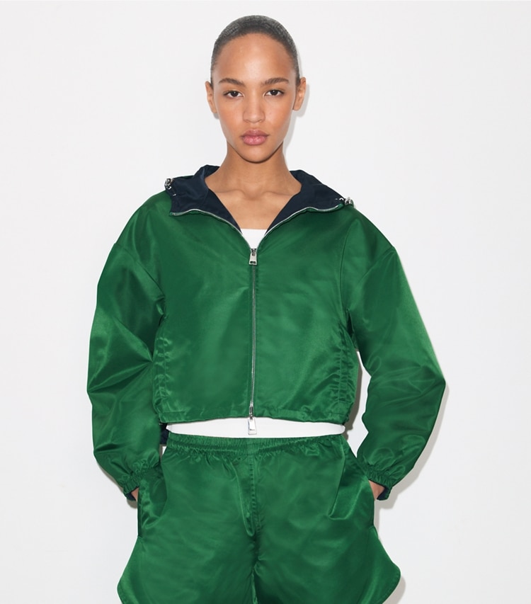 Tory Burch designer jackets Reversible Cropped Nylon Jacket in Dark Green / Navy on model detail