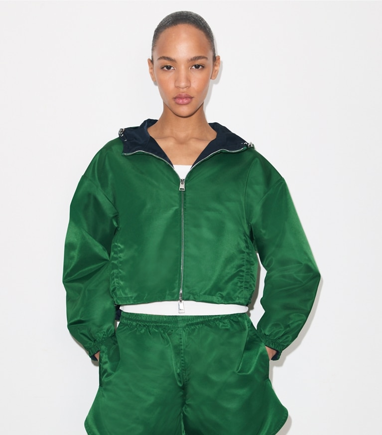 Tory Burch designer jackets Reversible Cropped Nylon Jacket in Dark Green / Navy on model detail