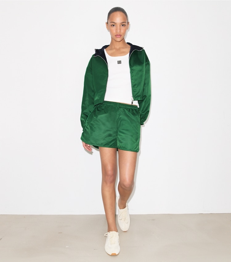 Tory Burch designer jackets Reversible Cropped Nylon Jacket in Dark Green / Navy on model front