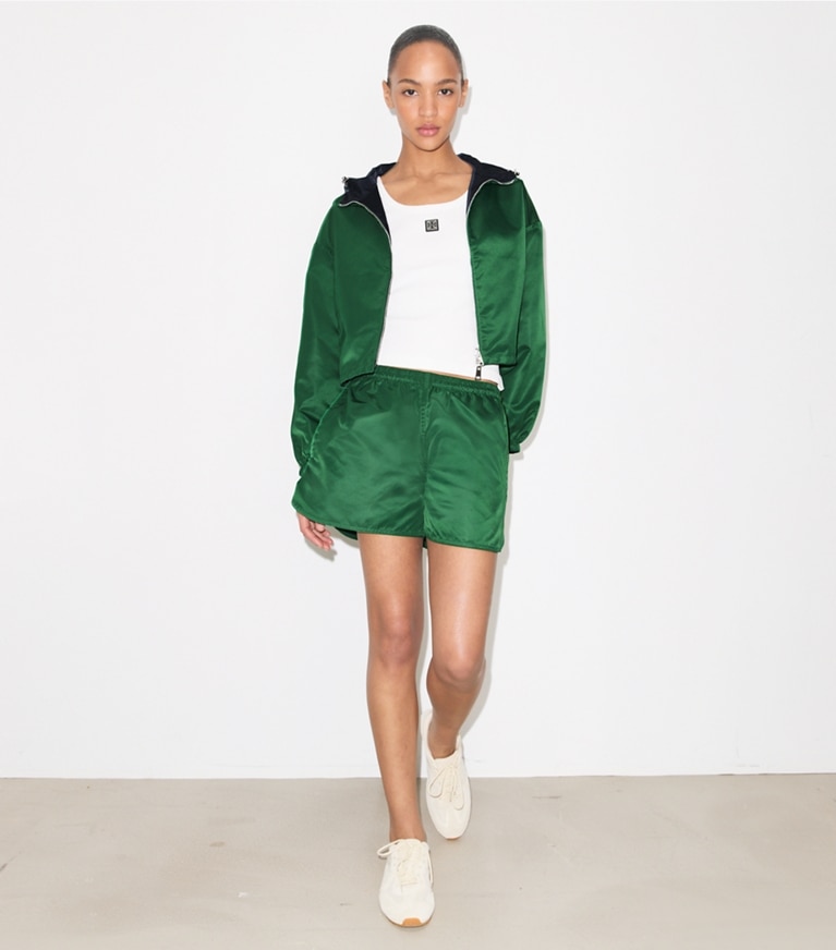 Tory Burch designer jackets Reversible Cropped Nylon Jacket in Dark Green / Navy on model front