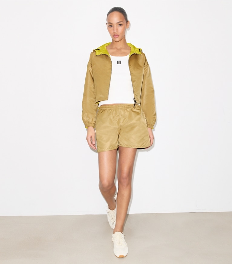 Tory Burch designer jackets Reversible Cropped Nylon Jacket in Green / Lemon on model front