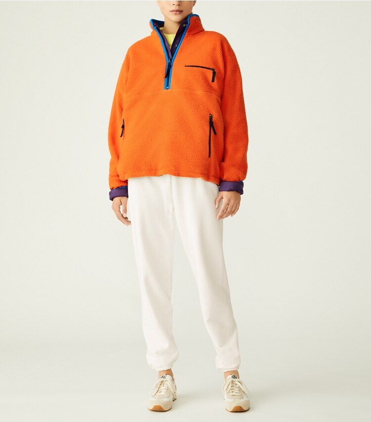 Tory Sport designer coats Reversible Nylon Fleece Pullover Jacket in Eggplant / Poppy Red on model front
